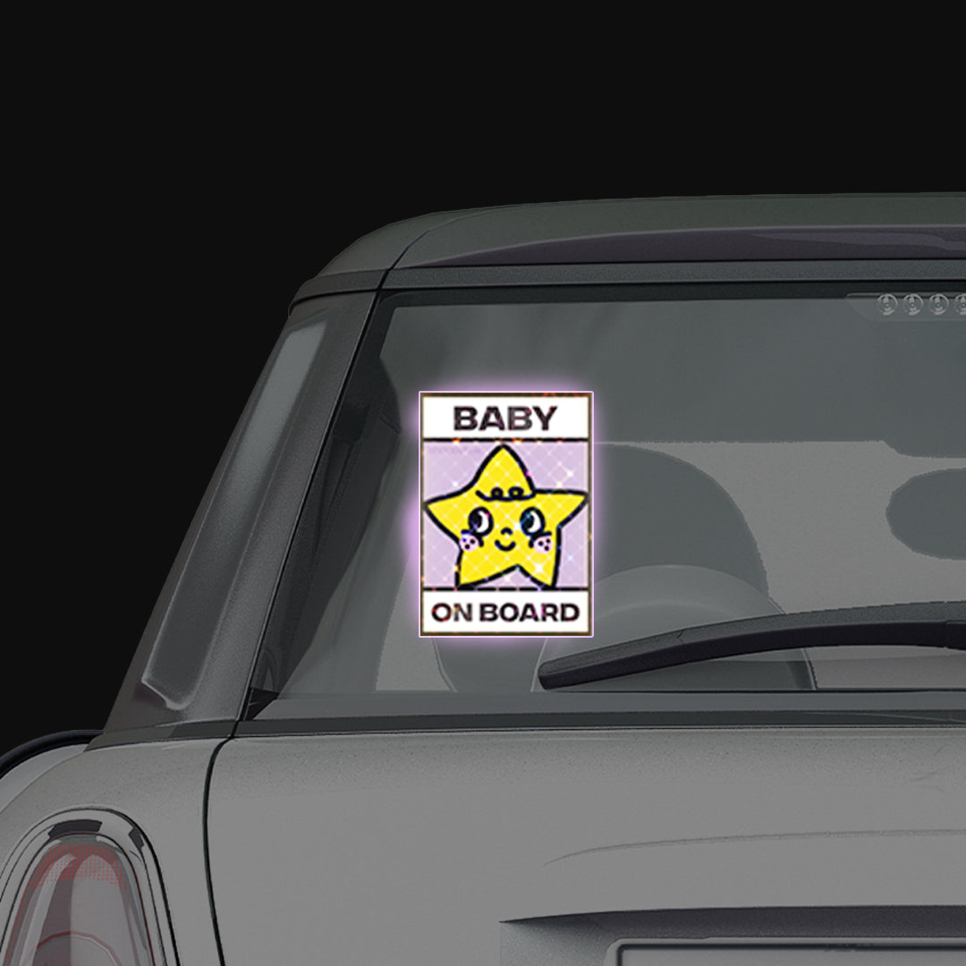 Shortcut Lab reflective ‘Baby On Board’ car window sticker with yellow star design displayed on rear window of a car.