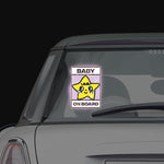 Shortcut Lab reflective ‘Baby On Board’ car window sticker with yellow star design displayed on rear window of a car.