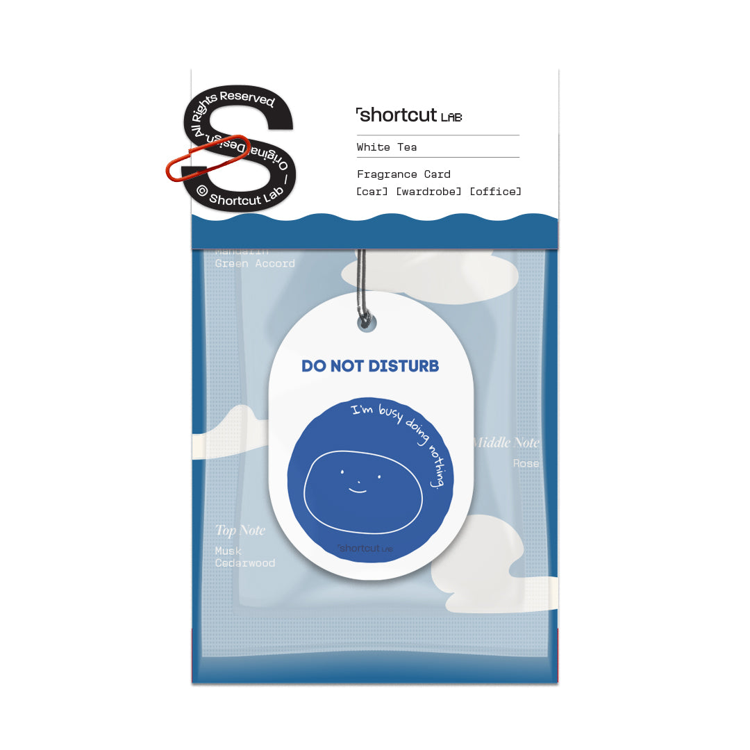 Shortcut Lab ‘Do Not Disturb’ car fragrance card in White Tea scent featuring blue smiling face design and text ‘I’m busy doing nothing,’ suitable for car, wardrobe, or office.