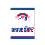 Shortcut Lab ‘Drive Safe’ reflective car tag packaging featuring winking clown face and Japanese text above bold blue-pink typography.