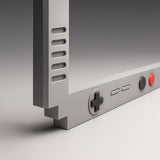 Close-up detail of Shortcut Lab GameBoy-inspired car number plate frame showing D-pad buttons and textured ABS plastic finish in matte grey.