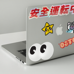 Shortcut Lab sticker collection displayed on a laptop, featuring ‘Googly Eyes,’ ‘OSTC,’ ‘Safely Transport in Japanese,’ and star character designs