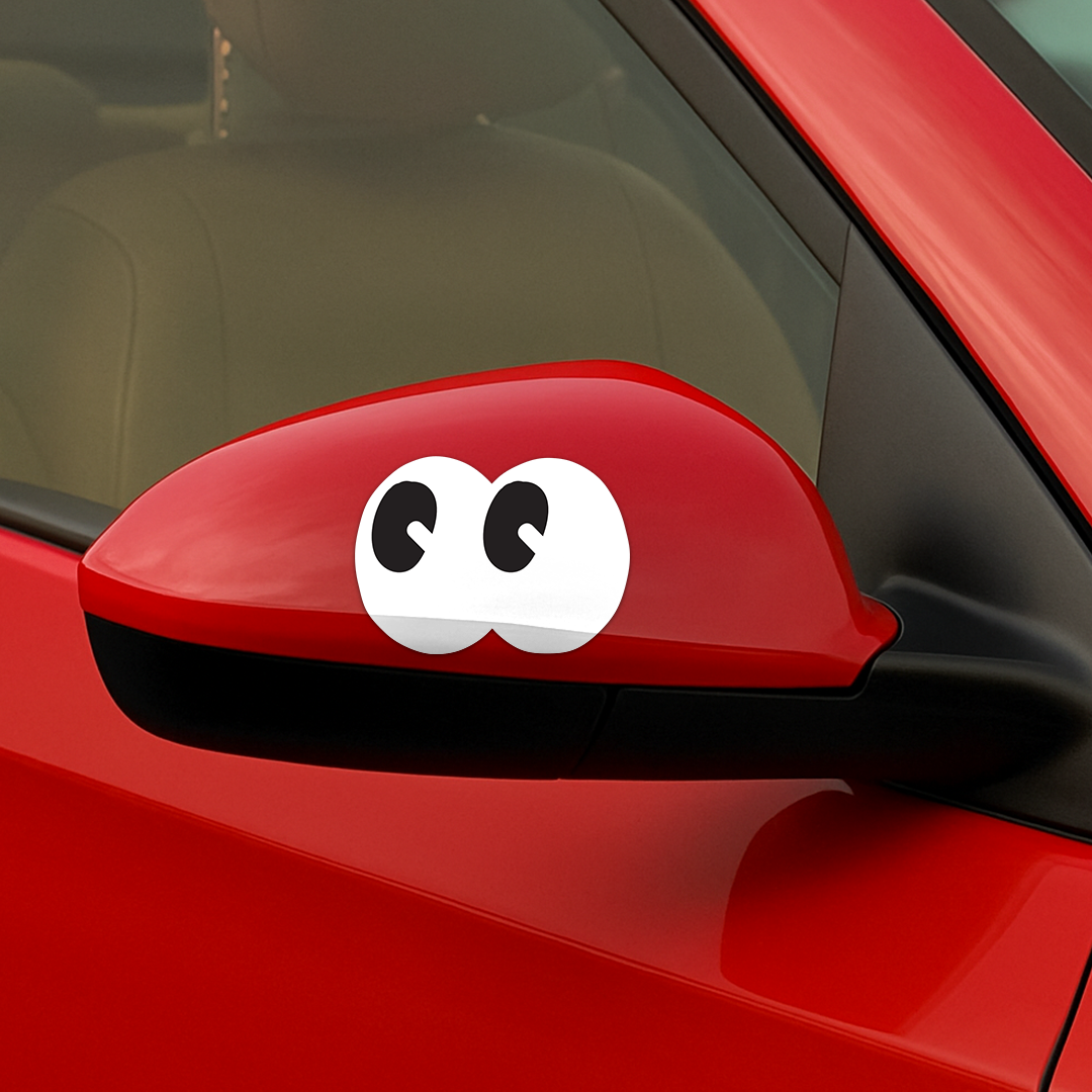 Shortcut Lab ‘Googly Eyes’ car sticker applied on red side mirror, featuring playful black and white cartoon eyes design