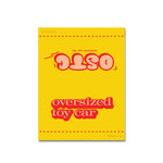 Shortcut Lab ‘OSTC Oversized Toy Car’ reflective car tag packaging in bright yellow with red retro lettering.