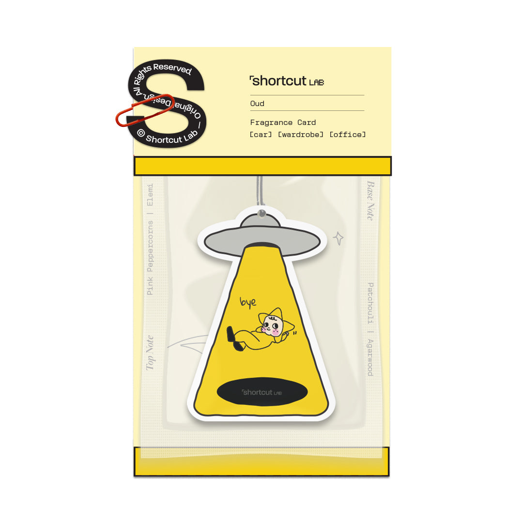Shortcut Lab car fragrance card in Oud scent featuring yellow UFO-shaped design with illustrated character and text ‘bye,’ suitable for car, wardrobe, or office use